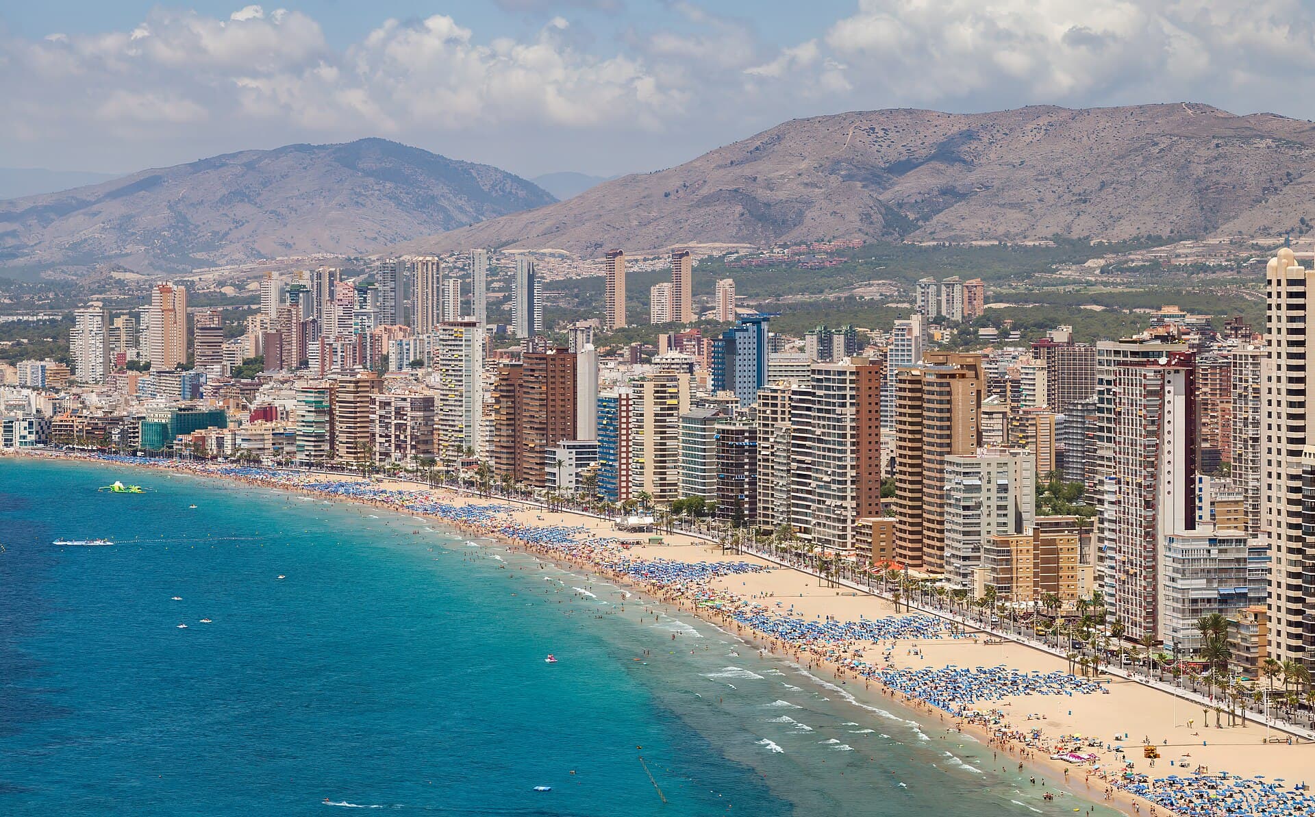 Levante beach and the high-rise skyline of Benidorm, with mountains behind