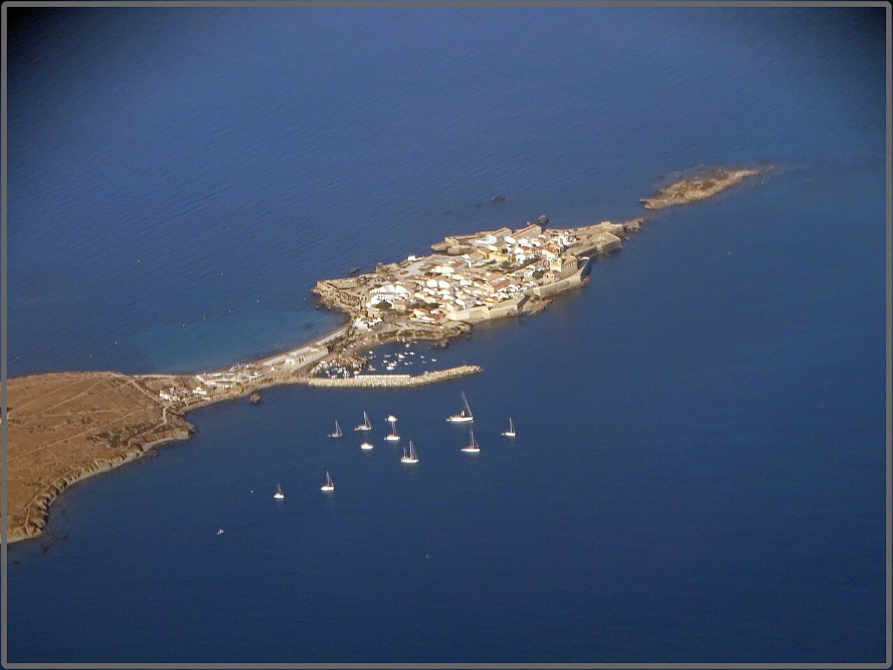 Aerial view of Tabarca island, with its walled village and boats at anchor