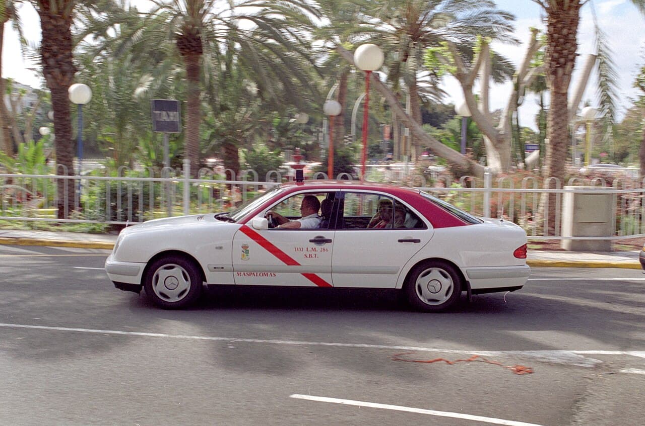 A white taxi on a road in Puerto Rico, in the south-west of Gran Canaria