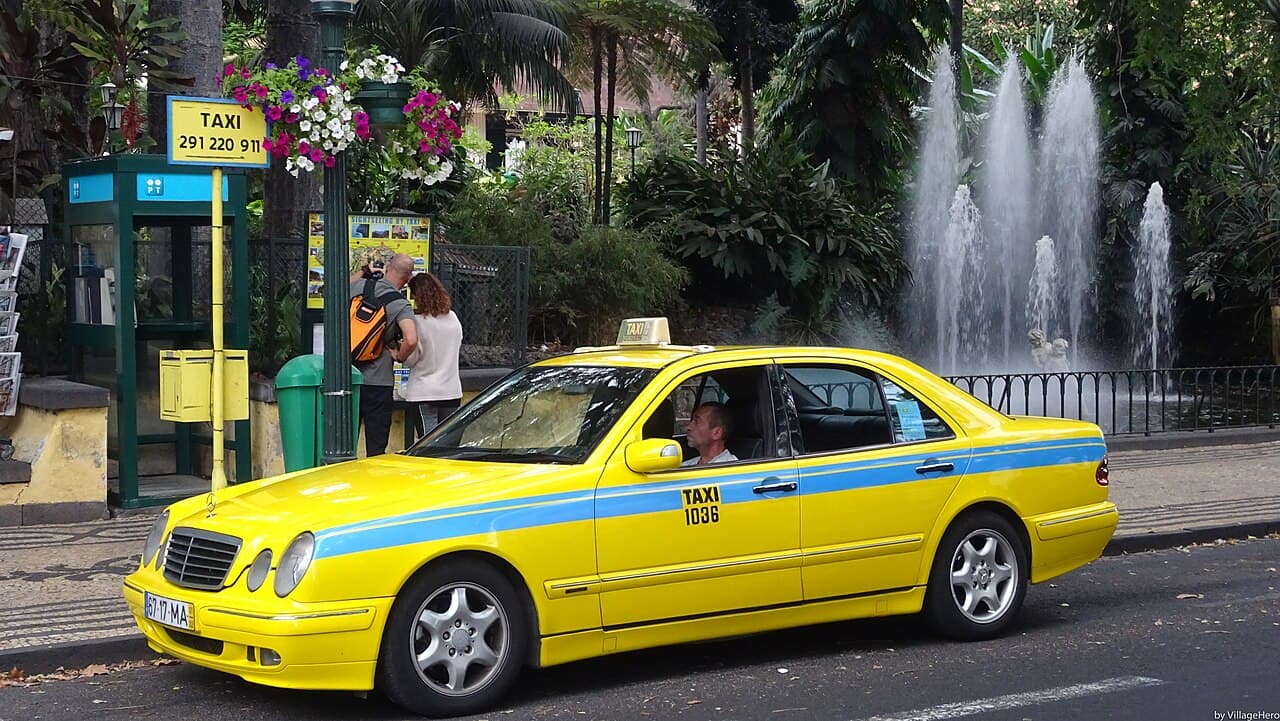 A yellow and blue taxi in central Funchal