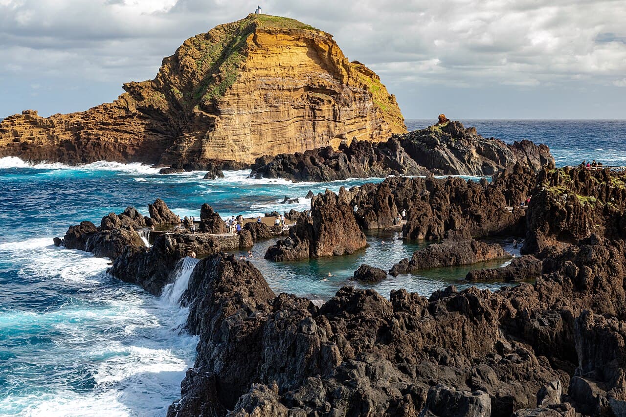 Volcanic rock pools at Porto Moniz with the Atlantic breaking beyond