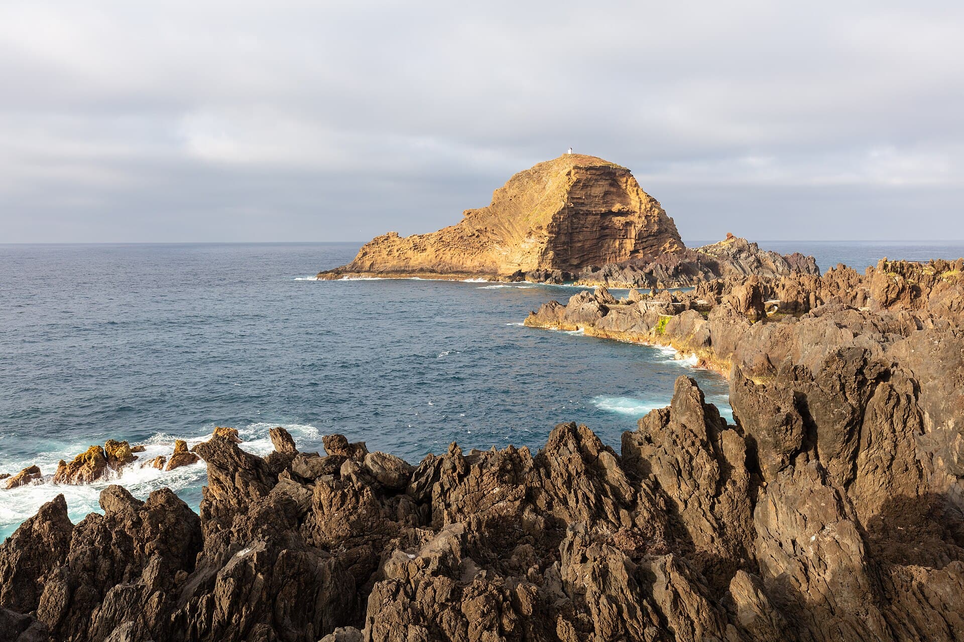 The natural pools of Porto Moniz below the village and its islet
