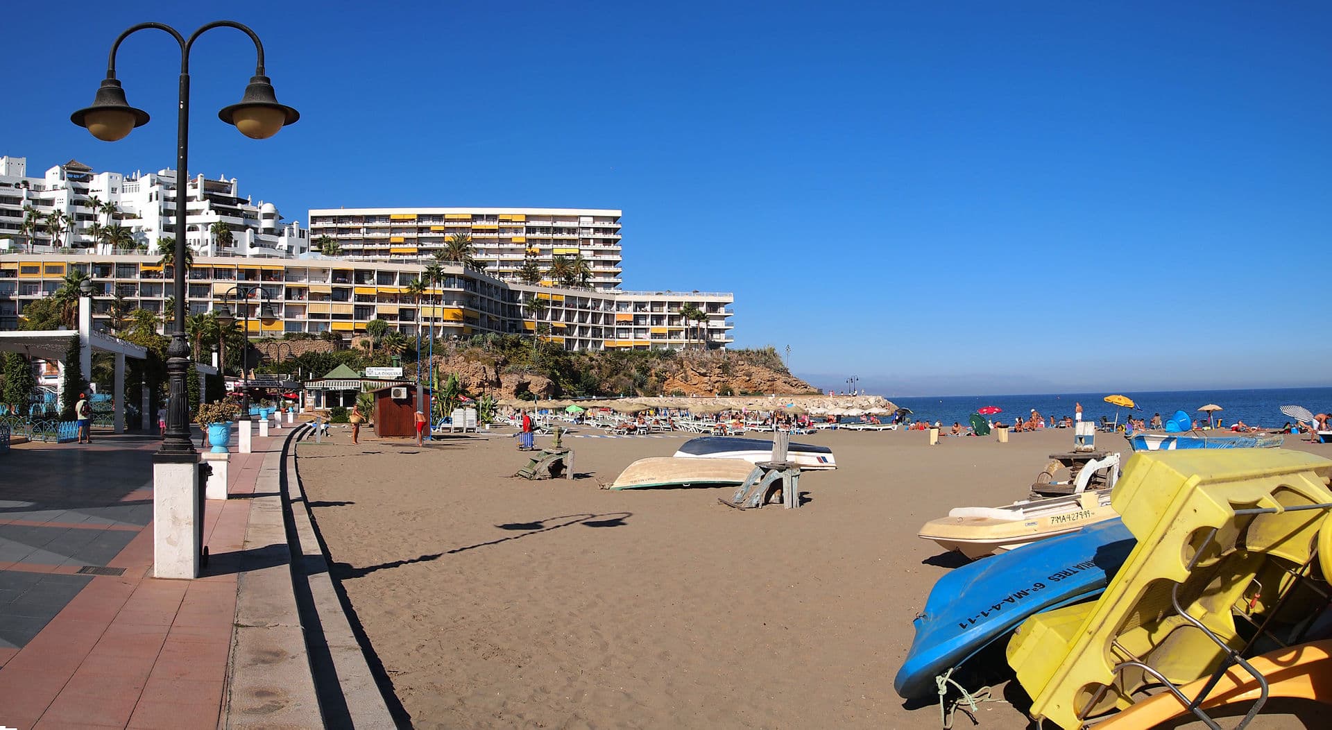 The beach at Torremolinos, with boats on the sand and buildings along the seafront