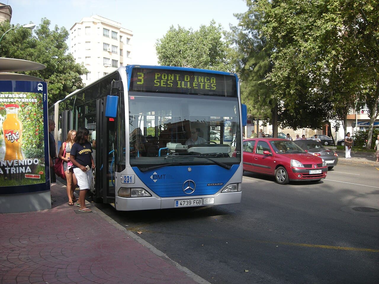 An EMT Palma city bus at a stop on Plaça del Progrés in Palma