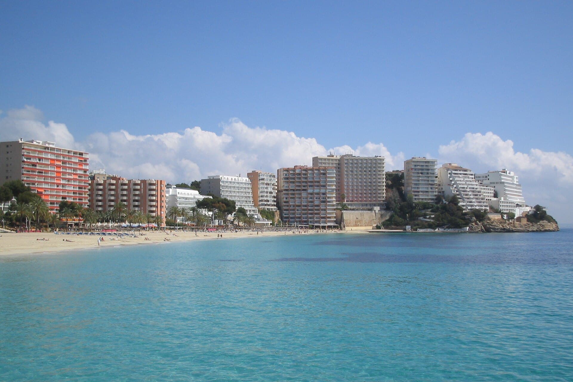 Turquoise water off the beach at Magaluf, with hotels along the shore