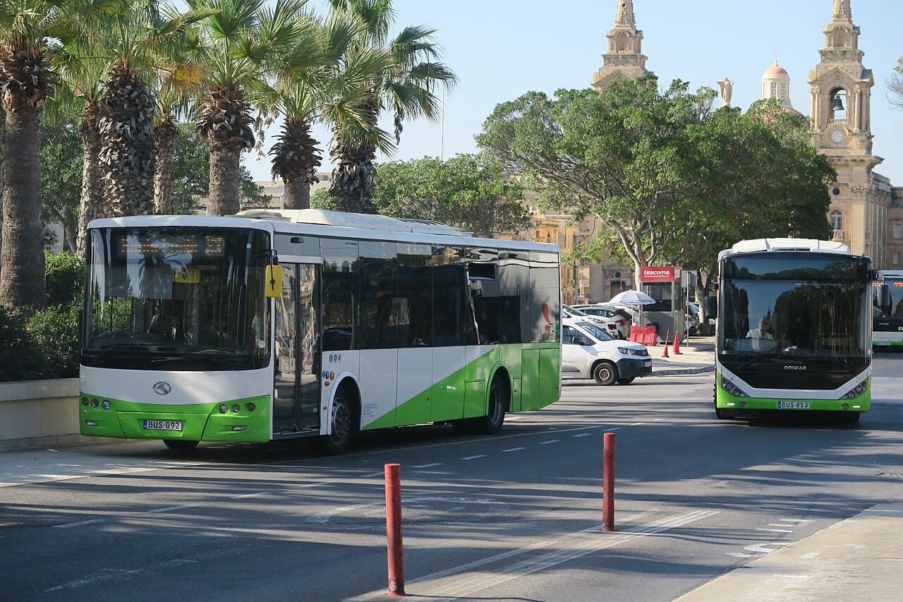 A green and white Malta Public Transport bus