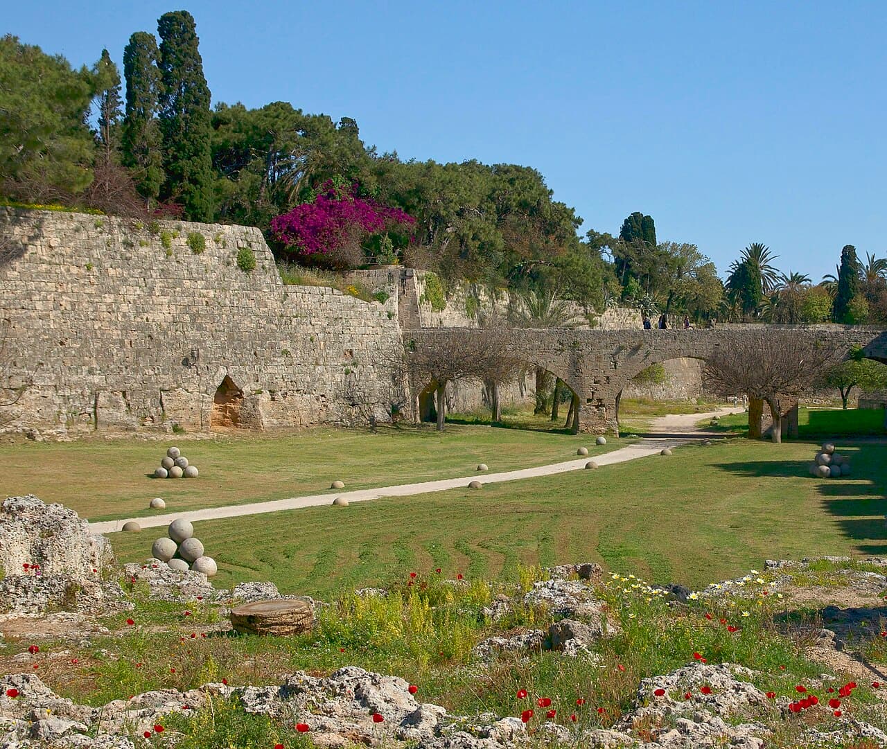 The grassy moat below the medieval walls of the Old Town of Rhodes