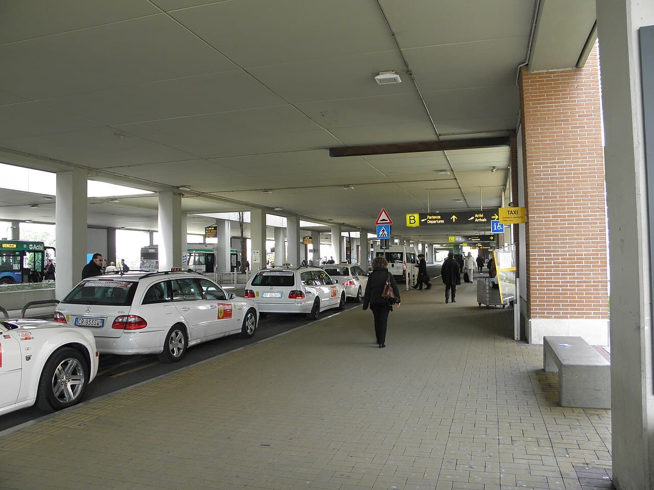 White taxis waiting in line outside the terminal at Venice Marco Polo Airport