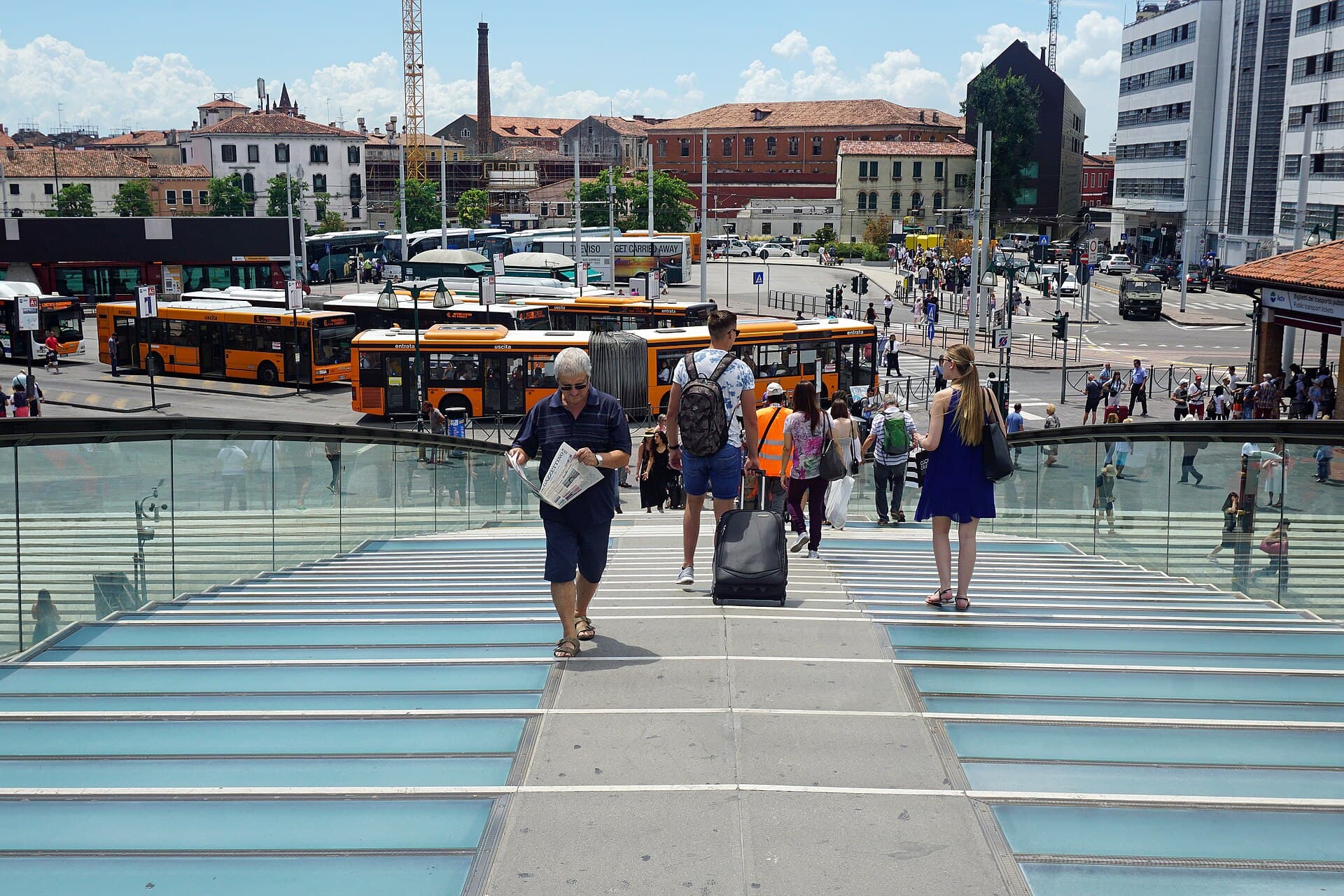 Travellers walking towards Piazzale Roma in Venice, where the road from the airport ends
