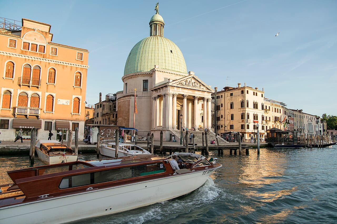 A varnished wooden water taxi on the Grand Canal in Venice