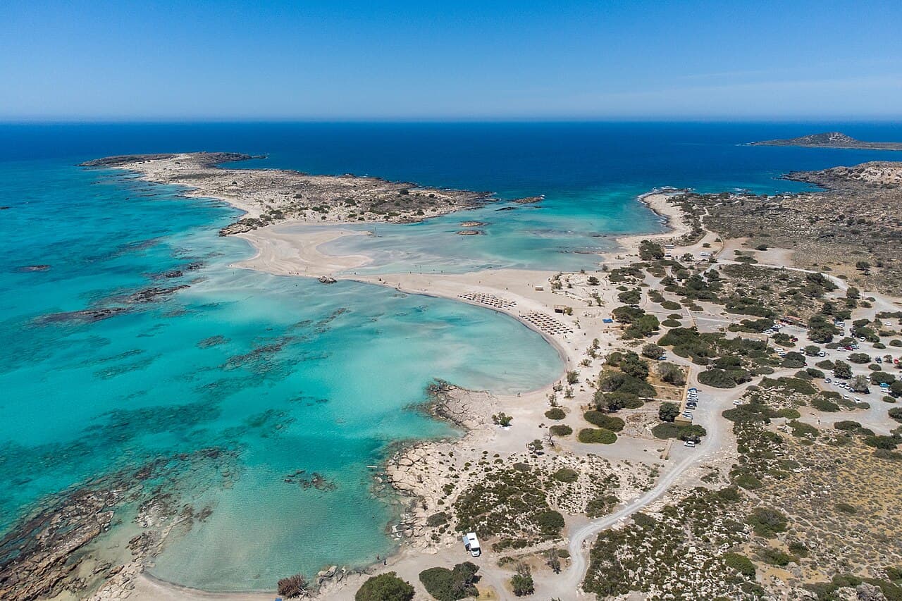 Aerial view of Elafonisi, with sandbars and turquoise shallows between the island and the coast
