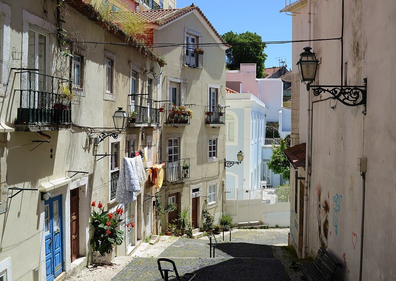 A narrow stepped lane between painted houses in Alfama, Lisbon